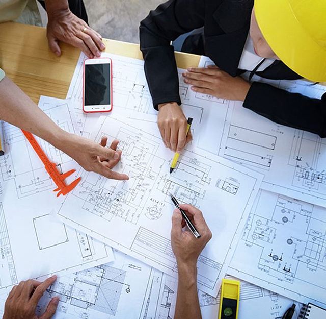 Engineers reviewing project drawings